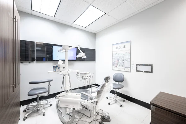 A dental exam chair at Torrance Dental Center with an overhead light attached