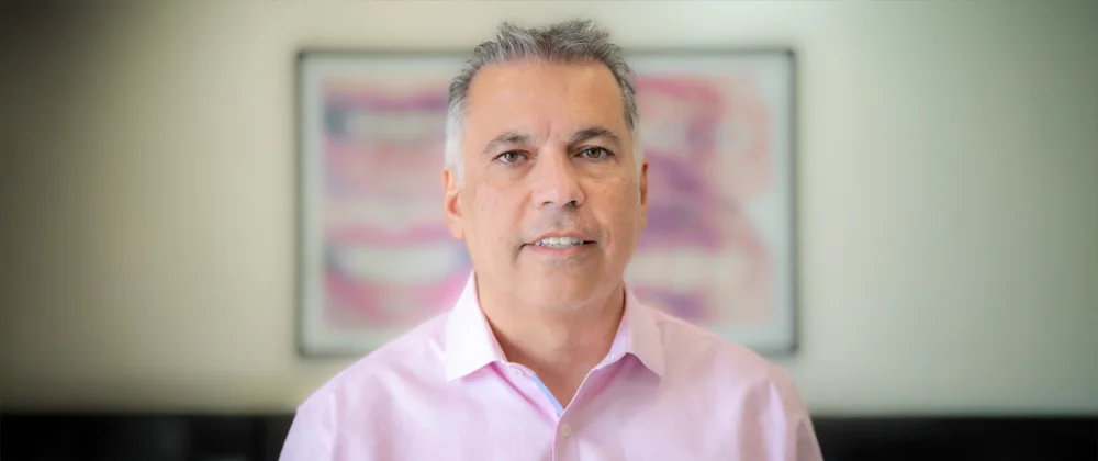 A professional photo of dentist Kamran Rafie from Torrance Dental Center standing inside the clinic