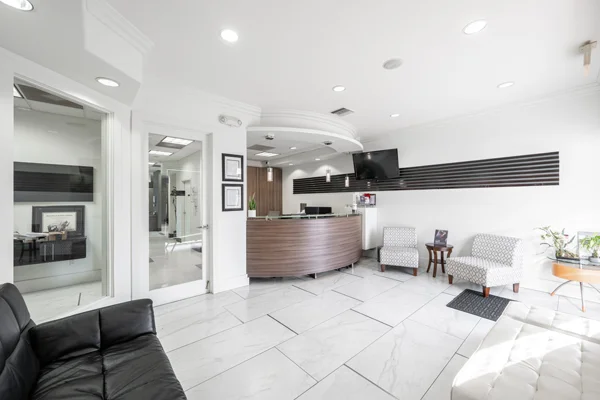 The Torrance Dental Center clinic lobby with white marble floorings and walls